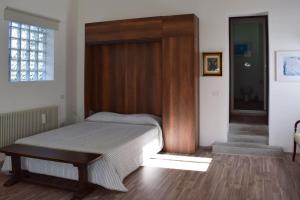 锡莱阿Open space Villa Miani的一间卧室配有一张带木制床头板的床