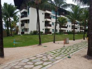 嘎林海斯港Estúdio equipado no Marulhos com vista do mar e do parque aquático, à beira-mar de Muro Alto, com restaurante, estacionamento e wi-fi, a 10 minutos de carro de Porto de Galinhas的棕榈树公园和建筑