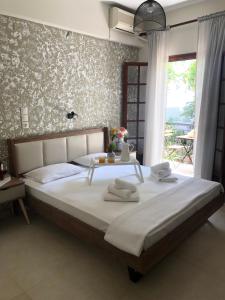 斯基亚索斯镇Armonia Guest House Skiathos的一间卧室配有一张大床和毛巾