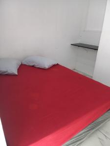大普拉亚Hostel Mar da Vila的床上有红毯