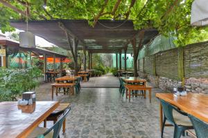 契拉勒Çıralı Orange Motel的一间设有木桌和椅子的餐厅