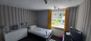 TrullWinchester Arms的一间小卧室,配有床和窗户