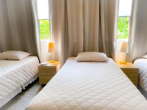 危地马拉Casa-Lucy的一间卧室设有两张床和两个窗户。