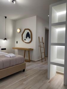 斯基亚索斯镇Olea White的卧室配有一张床,墙上设有镜子