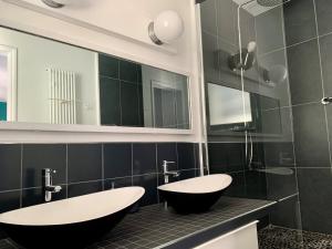 阿卡雄Villa Hyper Centre的浴室设有2个水槽、浴缸和镜子