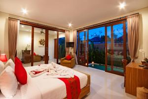 KetewelAishwarya Villa, Bali的一间卧室设有一张床和一个大窗户