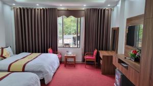 河江Friend Hotel Hà Giang的酒店客房设有两张床和窗户。