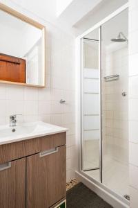 塞辛布拉Casa Alto da Serra Sesimbra的一间带水槽和玻璃淋浴的浴室