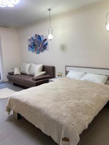 敖德萨New 2 bedroom apartment 71 m的一间卧室配有一张大床和一张沙发