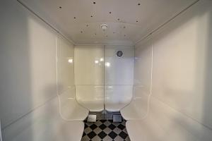 塔内安拉格谭恩帕克公寓酒店的一间带卫生间和玻璃墙的浴室