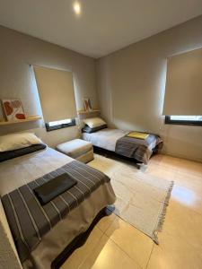 卢汉德库约Rincón de Chacras de Coria的一间卧室配有两张床和一张沙发。