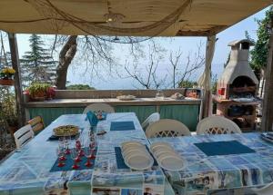 的里雅斯特Brezza Marina - Appartamento in villa fronte mare的天井上一张带蓝色桌布的桌子
