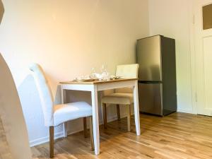 汉诺威Wohnung für 3 Gäste mit kostenlosen Parkplätzen nah am Maschsee的一张带两把椅子的小桌子和一台冰箱