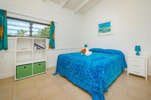 拉罗汤加Aroa Beachside Resort的一间卧室配有一张床、一个梳妆台和一扇窗户。