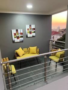 马普托INCANTO RESIDENCIAL的阳台配有2把黄色椅子和1张沙发