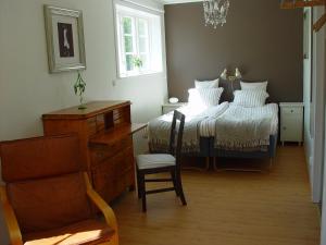 BrokindSundsmåla Landsbygdshotell的一间卧室配有一张带椅子和桌子的床
