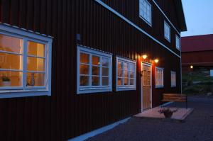 BrokindSundsmåla Landsbygdshotell的一座有门的建筑,旁边还有长凳