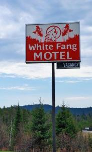 沃瓦White Fang Motel的 ⁇ 上白色农场汽车旅馆的标志