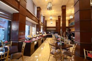 马尼拉Bayview Park Hotel Manila的餐厅内带桌椅的用餐室