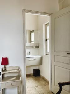 阿尔勒Appartement aux Arènes的白色的浴室设有水槽和镜子