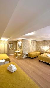 威尼斯Hotel Apostoli Garden的大房间设有两张床和一张桌子
