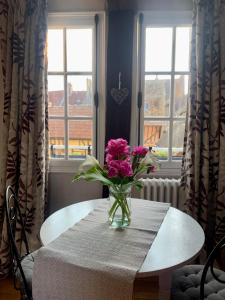 弗农La petite duchesse的窗前桌子上一束粉红色的花