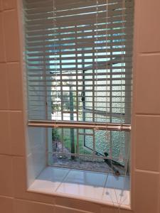 SpringfonteinSpringfontein Guesthouse的浴室的窗户上装有百叶窗