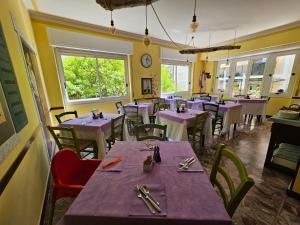 莱圭利亚Villa Pina的餐厅用餐室配有紫色的桌椅
