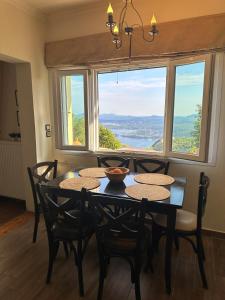 SpartýlasLorantina House_ Holidays in Corfu的一间带桌椅和窗户的用餐室