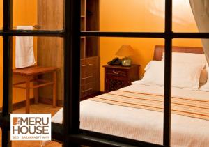 NkubuThe Meru House的一间卧室设有一张床和一个窗口