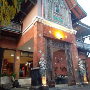 日惹Hotel Bifa Yogyakarta的前面有雕像的建筑