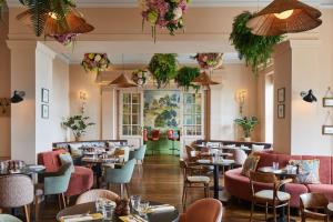 伯恩茅斯万豪伯恩茅斯高崖酒店的一间带桌椅和鲜花的餐厅