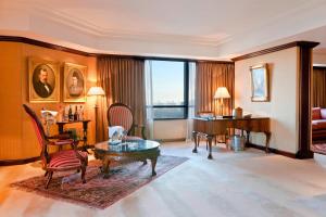 布宜诺斯艾利斯布宜诺斯艾利斯公园大厦豪华精选酒店的一间带三角钢琴的客厅和一间带桌子的房间