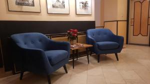 维也纳克里姆特酒店的候诊室配有2把蓝色椅子和1张桌子