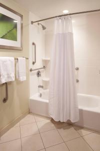 埃文斯维尔埃文斯维尔东埕万怡酒店的浴室配有淋浴帘和浴缸。