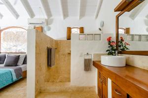 拉斯特拉纳斯Casa Picaflor的一间带水槽的浴室和一张位于客房内的床