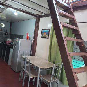 San IsidroKlay's tiny home的厨房配有桌椅和冰箱。