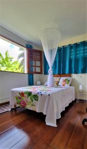 Rivière-PiloteLa Visite Tropicale的一间卧室配有一张带天蓬的白色床