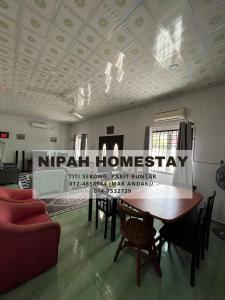 巴力文打Nipah Homestay Parit Buntar的一间设有桌椅和天花板标志的房间