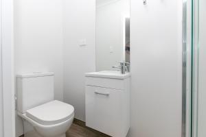 汉密尔顿Comfy Stay Close to City Center的白色的浴室设有卫生间和水槽。