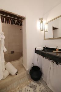 马拉喀什Riad Les Hirondelles Boutique Hotel的浴室配有盥洗盆和浴缸。
