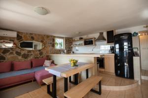 罗加克Villa Zdena的厨房以及带沙发和桌子的客厅。