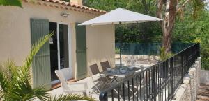 PierrevertUne maison en Provence的一个带桌子和遮阳伞的庭院
