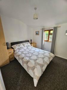 坎伯恩Picturesque Cabin in Cornwall的一间卧室设有一张大床和一个窗户。