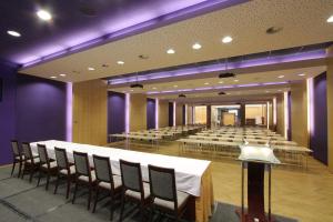 布拉格沓酒店的大房间设有桌椅和紫色照明