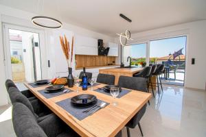 普拉Villa Mina with a private pool in Pula的厨房以及带木桌和椅子的用餐室。