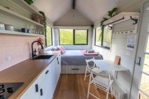 TooboracHeathcote Valley Tiny House - Tiny Stays的一个小房子里的一个小厨房,配有床