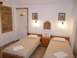 伊奥斯乔拉Vasilis Place Ιos的带窗户的客房内设有两张单人床。
