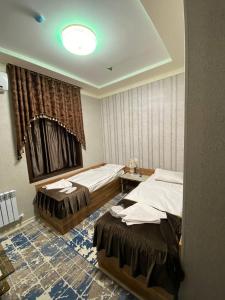 塔什干Davan LUX的酒店客房设有两张床和窗户。