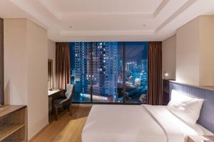 芽庄ARECA HOTEL NHA TRANG的酒店客房享有城市美景,配有一张床。